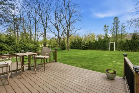a view of a deck with table and chairs and wooden floor