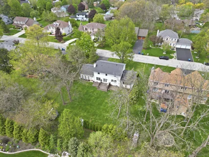 an aerial view of a house with a yard