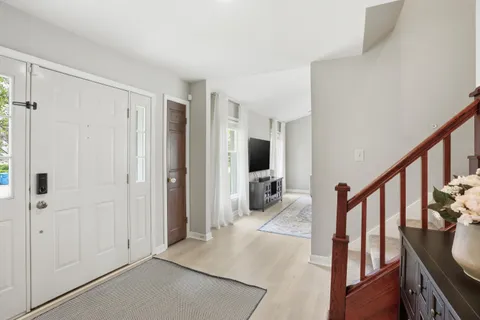a view of a livingroom with wooden floor and furniture