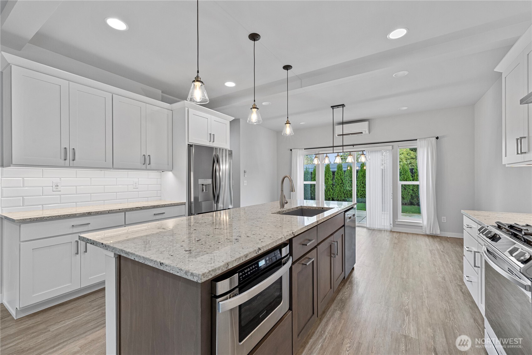 529 Ball Street, Unit A & B Sedro-Woolley, WA 98284 - Photo 11 of 31 a kitchen with a stove center island wooden floor cabinets and a window
