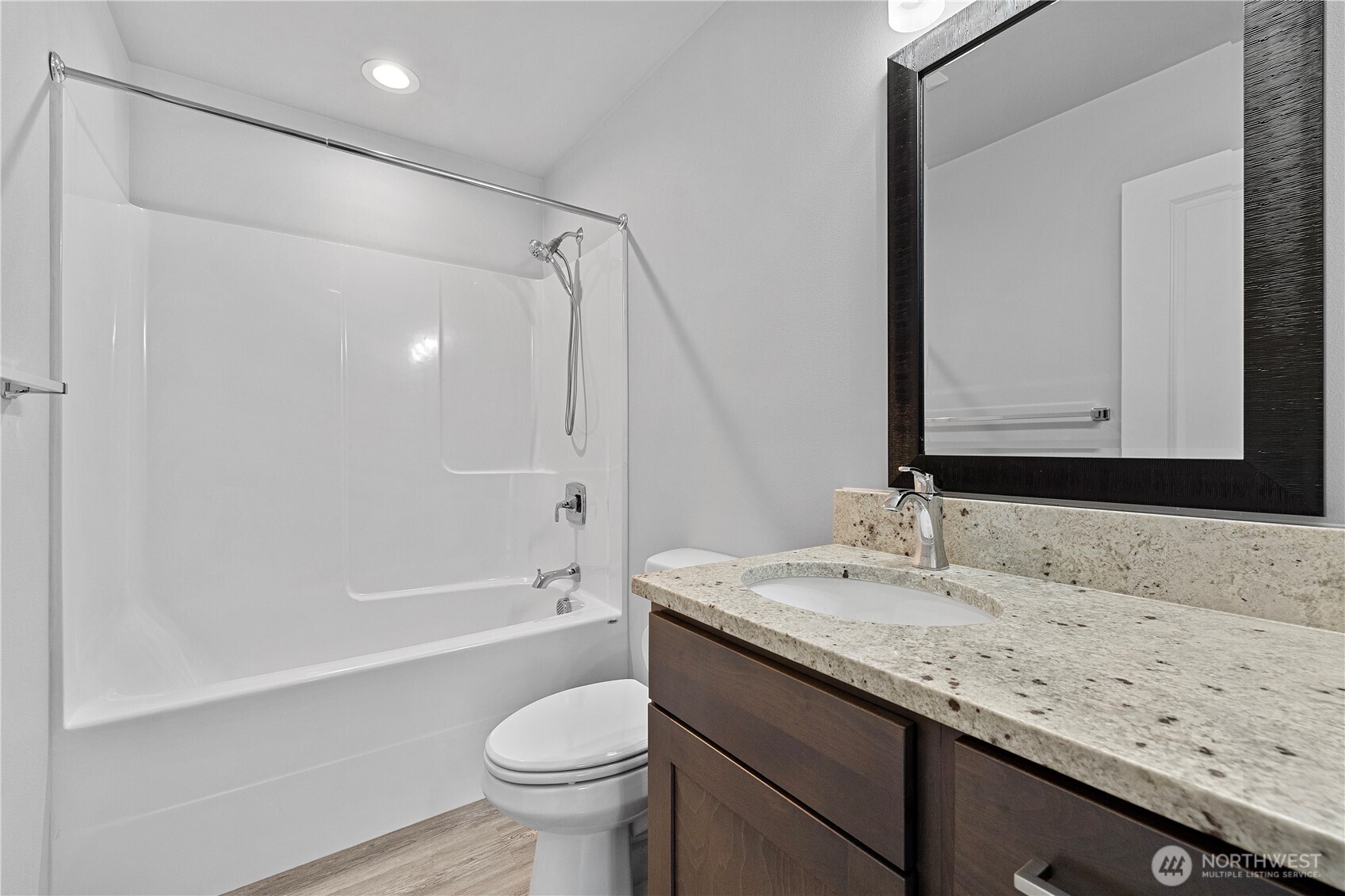 529 Ball Street, Unit A & B Sedro-Woolley, WA 98284 - Photo 17 of 31 a bathroom with a granite countertop sink a toilet and a large mirror