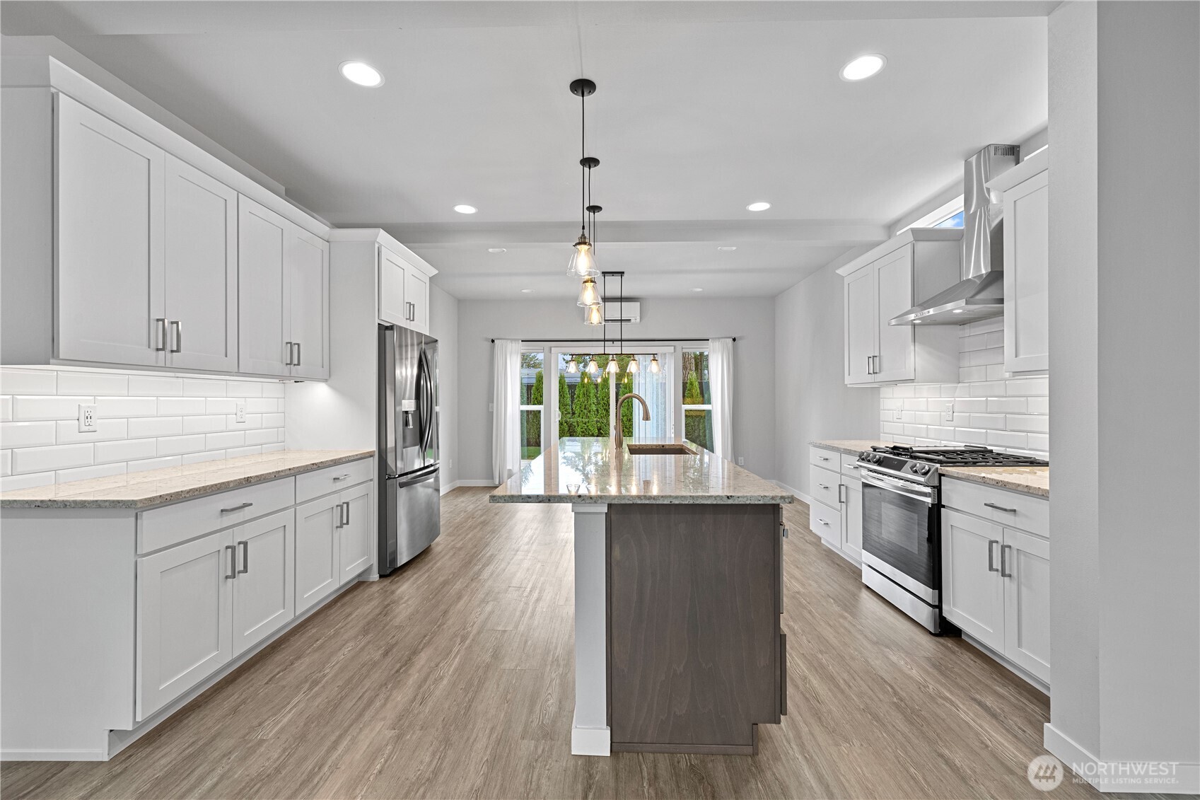 529 Ball Street, Unit A & B Sedro-Woolley, WA 98284 - Photo 9 of 31 a kitchen with stainless steel appliances granite countertop hardwood floor sink stove and wooden cabinets