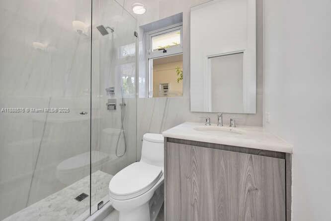 621 North Mashta Drive Key Biscayne, FL 33149 - Photo 13 of 34 a bathroom with a granite countertop sink toilet and shower