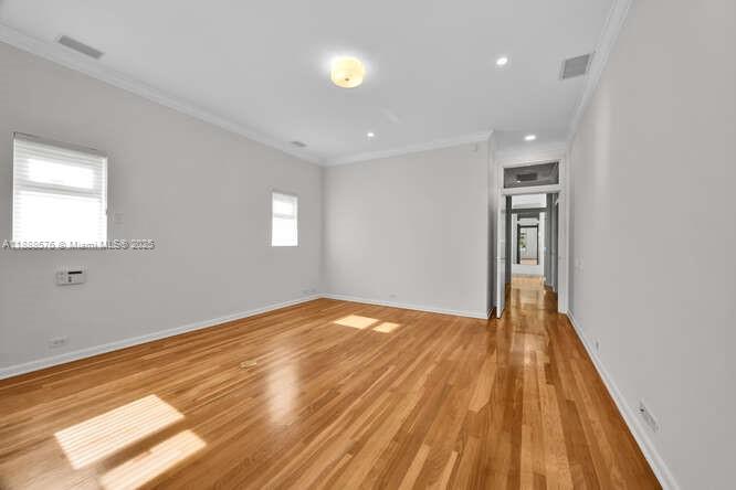 621 North Mashta Drive Key Biscayne, FL 33149 - Photo 14 of 34 a view of empty room with wooden floor and fan