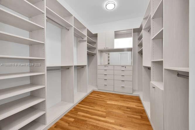 621 North Mashta Drive Key Biscayne, FL 33149 - Photo 16 of 34 a view of walk in closet with empty racks