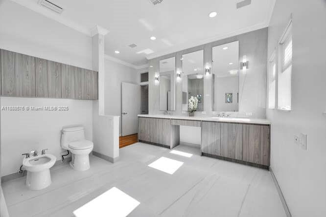 621 North Mashta Drive Key Biscayne, FL 33149 - Photo 18 of 34 a bathroom with a double vanity sink mirror and toilet