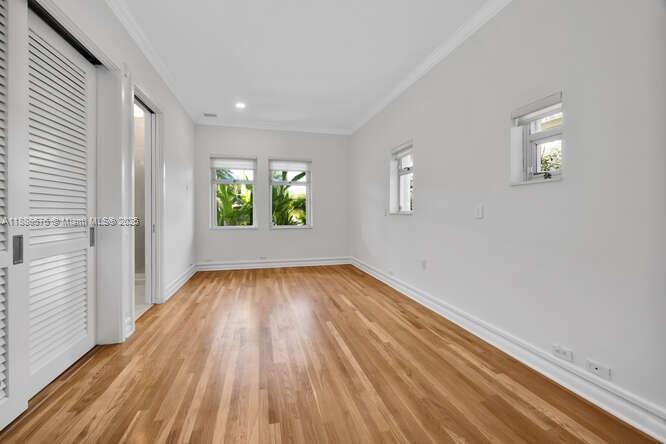 621 North Mashta Drive Key Biscayne, FL 33149 - Photo 20 of 34 wooden floor in an empty room with a window