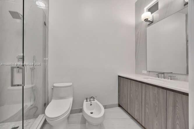 621 North Mashta Drive Key Biscayne, FL 33149 - Photo 21 of 34 a white toilet sitting next to a bathroom sink