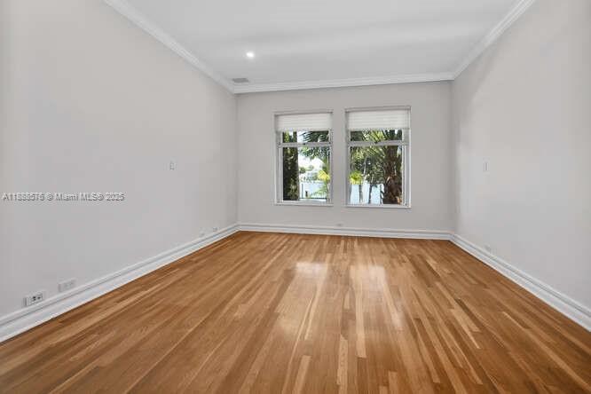 621 North Mashta Drive Key Biscayne, FL 33149 - Photo 22 of 34 an empty room with wooden floor and windows