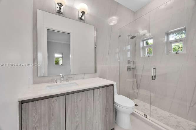 621 North Mashta Drive Key Biscayne, FL 33149 - Photo 25 of 34 a bathroom with a sink a toilet and shower