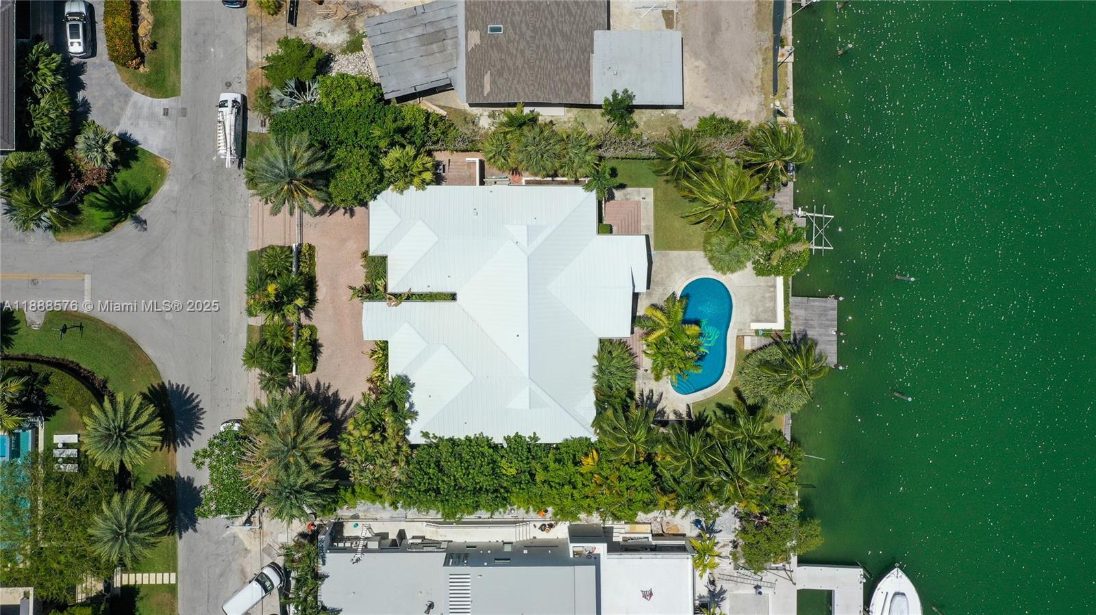 621 North Mashta Drive Key Biscayne, FL 33149 - Photo 33 of 34 an aerial view of a house with a yard and trees in front of it