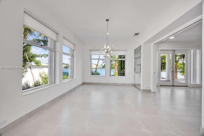 621 North Mashta Drive Key Biscayne, FL 33149 - Photo 8 of 34 a view of an empty room with window and wooden floor