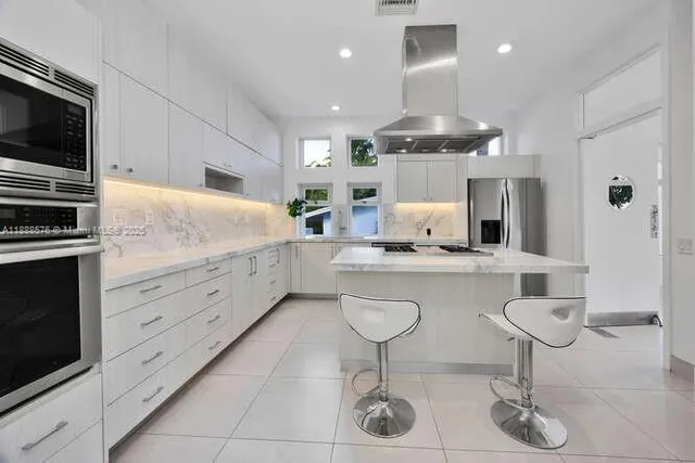 a bathroom with a double vanity sink mirror and toilet