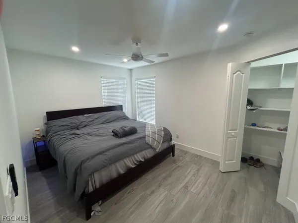 a spacious bedroom with a bed and a walk in closet
