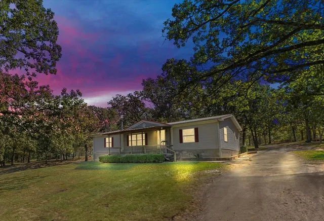 a view of a yard with large trees