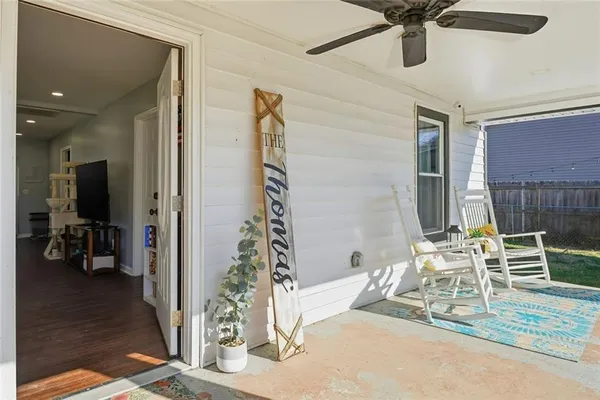 a view of a livingroom with a chair and the ceiling fan