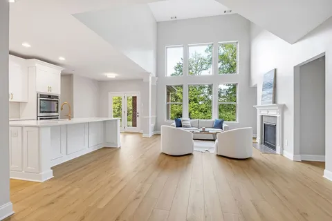 a living room with furniture and large windows