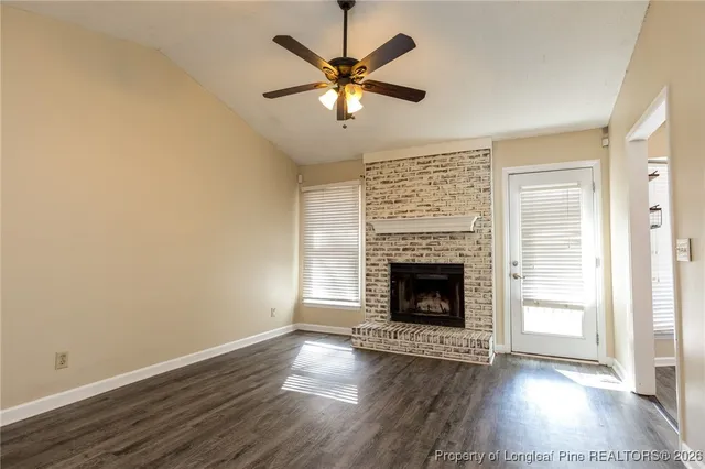 a view of an empty room and wooden floor