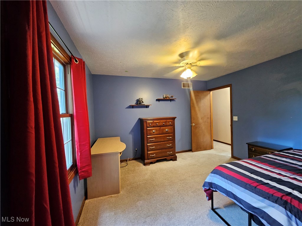 6247 Hathaway Road Cleveland, OH 44125 - Photo 36 of 42 Bedroom with light colored carpet, a textured ceiling, and ceiling fan