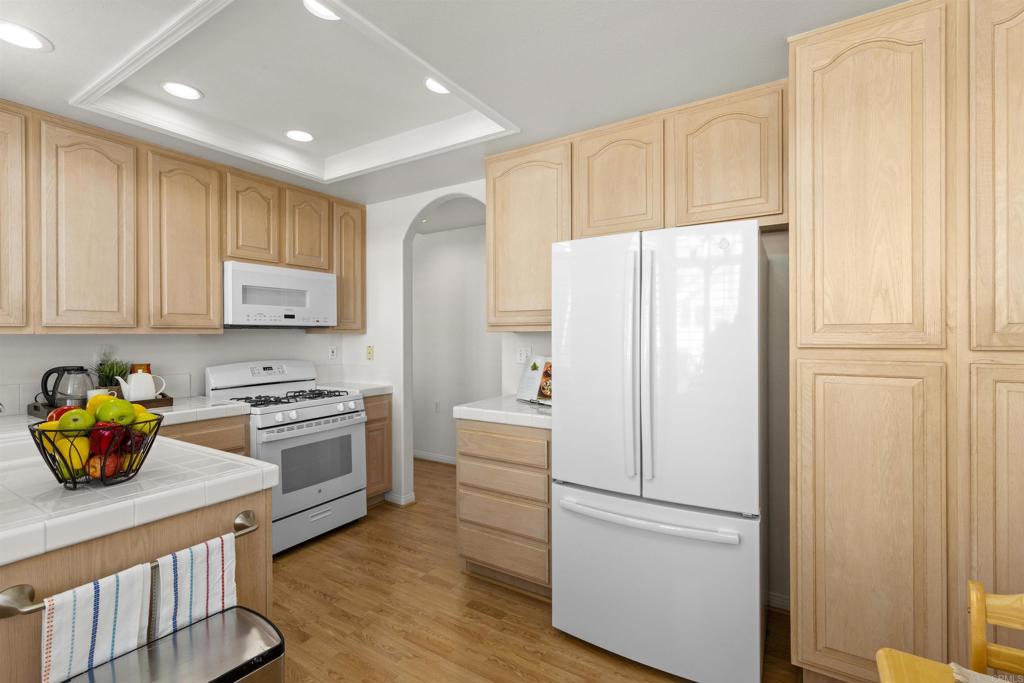 3305 Genoa Way, Unit 90 Oceanside, CA 92056 - Photo 11 of 35 a kitchen with stainless steel appliances granite countertop a refrigerator sink and stove