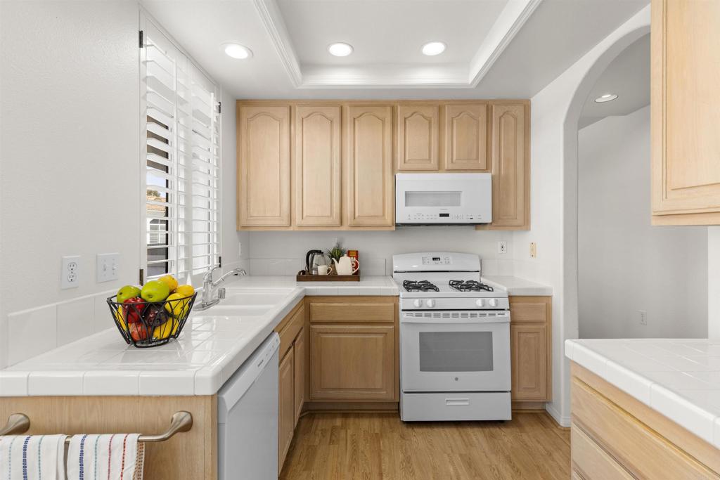 3305 Genoa Way, Unit 90 Oceanside, CA 92056 - Photo 12 of 35 a kitchen with a stove a sink and a microwave