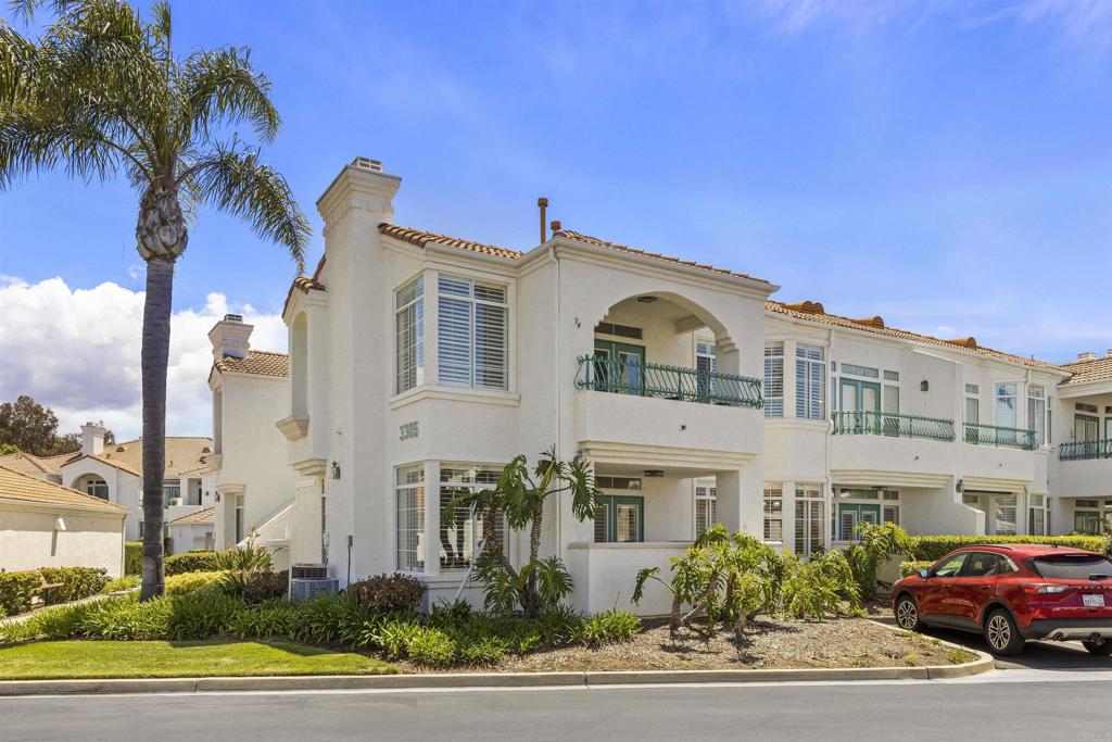3305 Genoa Way, Unit 90 Oceanside, CA 92056 - Photo 2 of 35 a front view of a residential apartment building with a yard