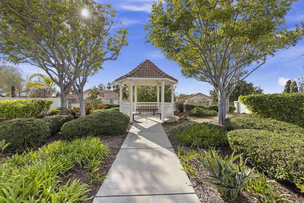 3305 Genoa Way, Unit 90 Oceanside, CA 92056 - Photo 29 of 35 a front view of a house with a yard and potted plants