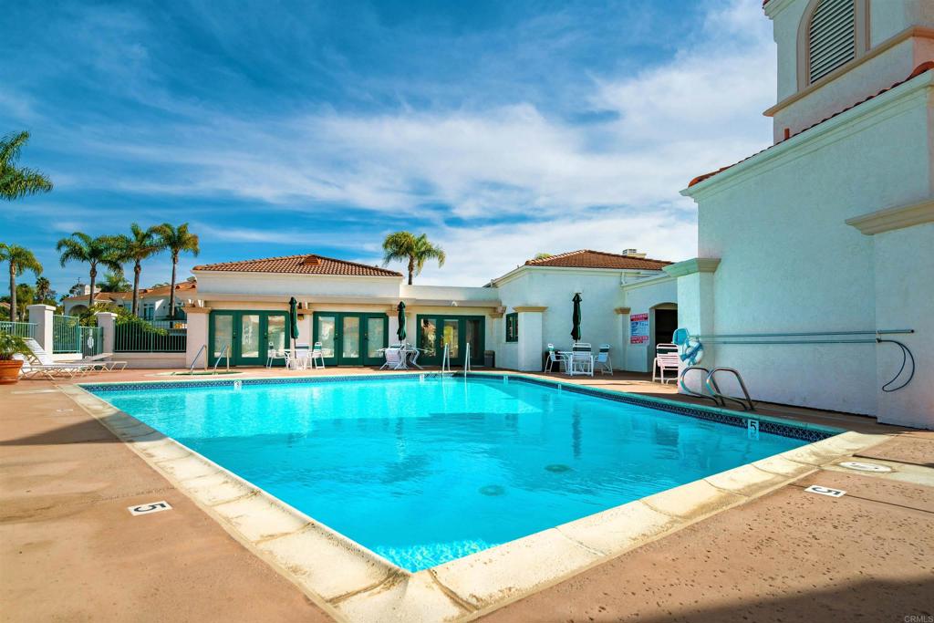 3305 Genoa Way, Unit 90 Oceanside, CA 92056 - Photo 32 of 35 a view of swimming pool with lawn chairs and large trees