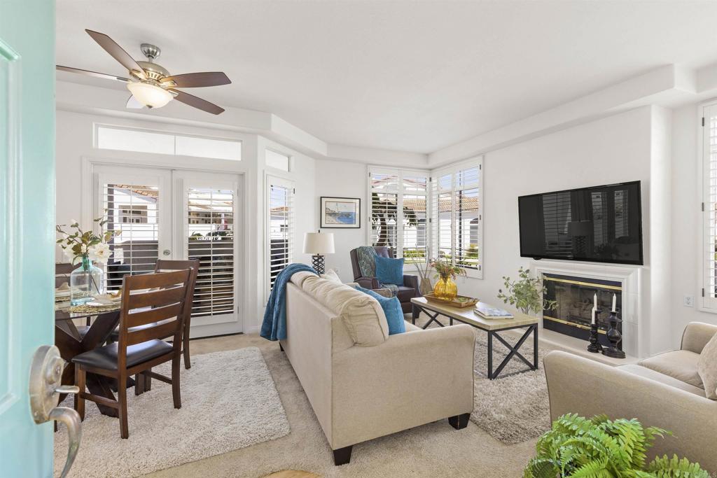 3305 Genoa Way, Unit 90 Oceanside, CA 92056 - Photo 5 of 35 a living room with furniture a flat screen tv and a fireplace