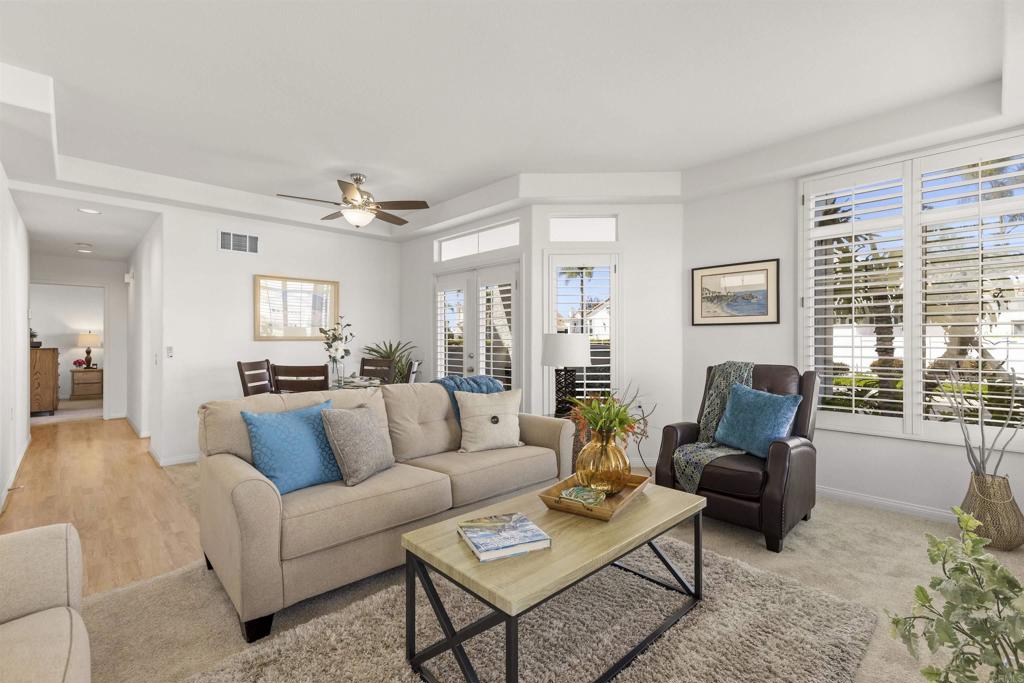 3305 Genoa Way, Unit 90 Oceanside, CA 92056 - Photo 8 of 35 a living room with furniture and a large window