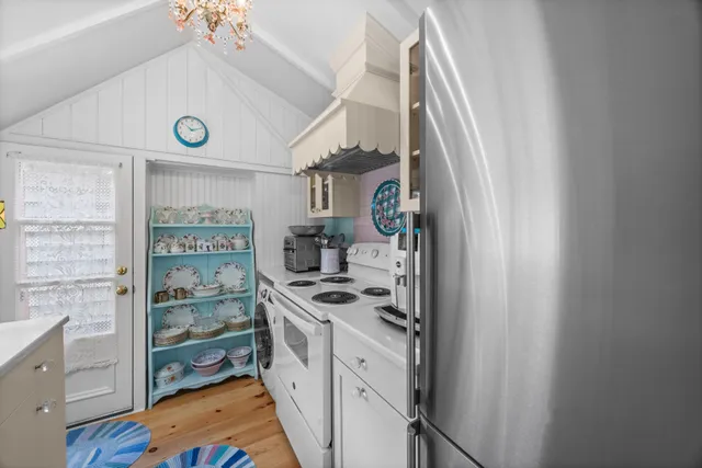 a kitchen with a refrigerator and a stove