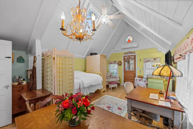 a bedroom with furniture and a flat screen tv