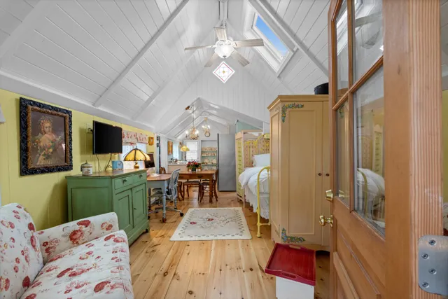 a bed room with a bed a flat screen tv and a window