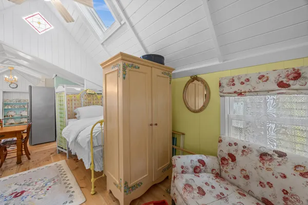 a bedroom with a bed and a mirror