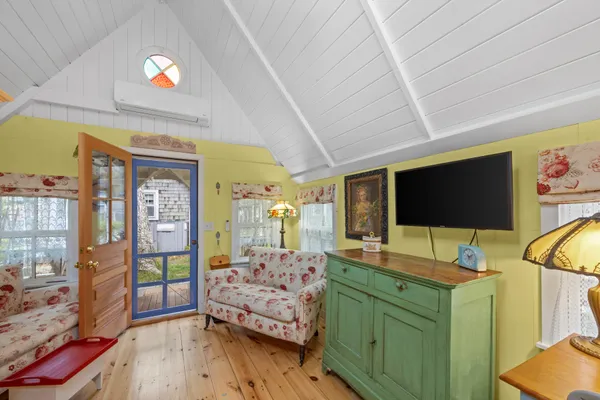 a bedroom with furniture and a flat screen tv