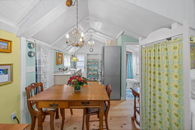 a view of a dining room with furniture and chandelier