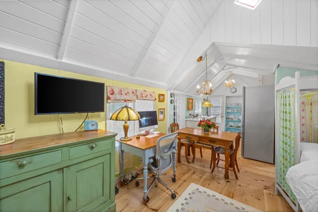 a room with lots of wooden furniture and a flat screen tv