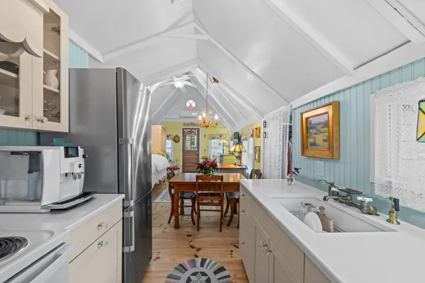a large kitchen with a sink appliances and cabinets