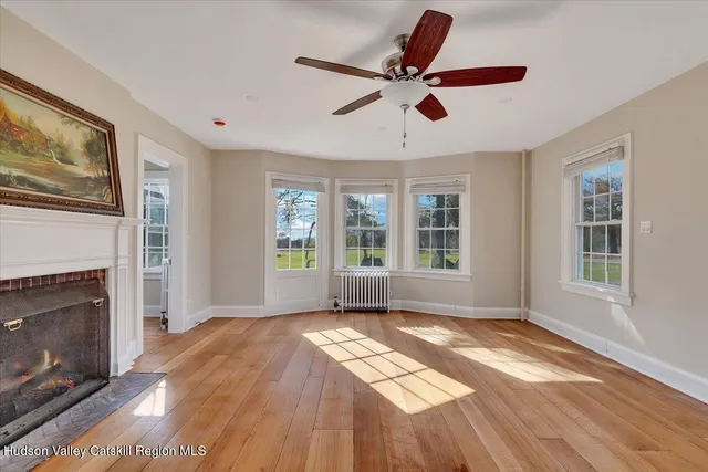 a view of a room with wooden floor and fence