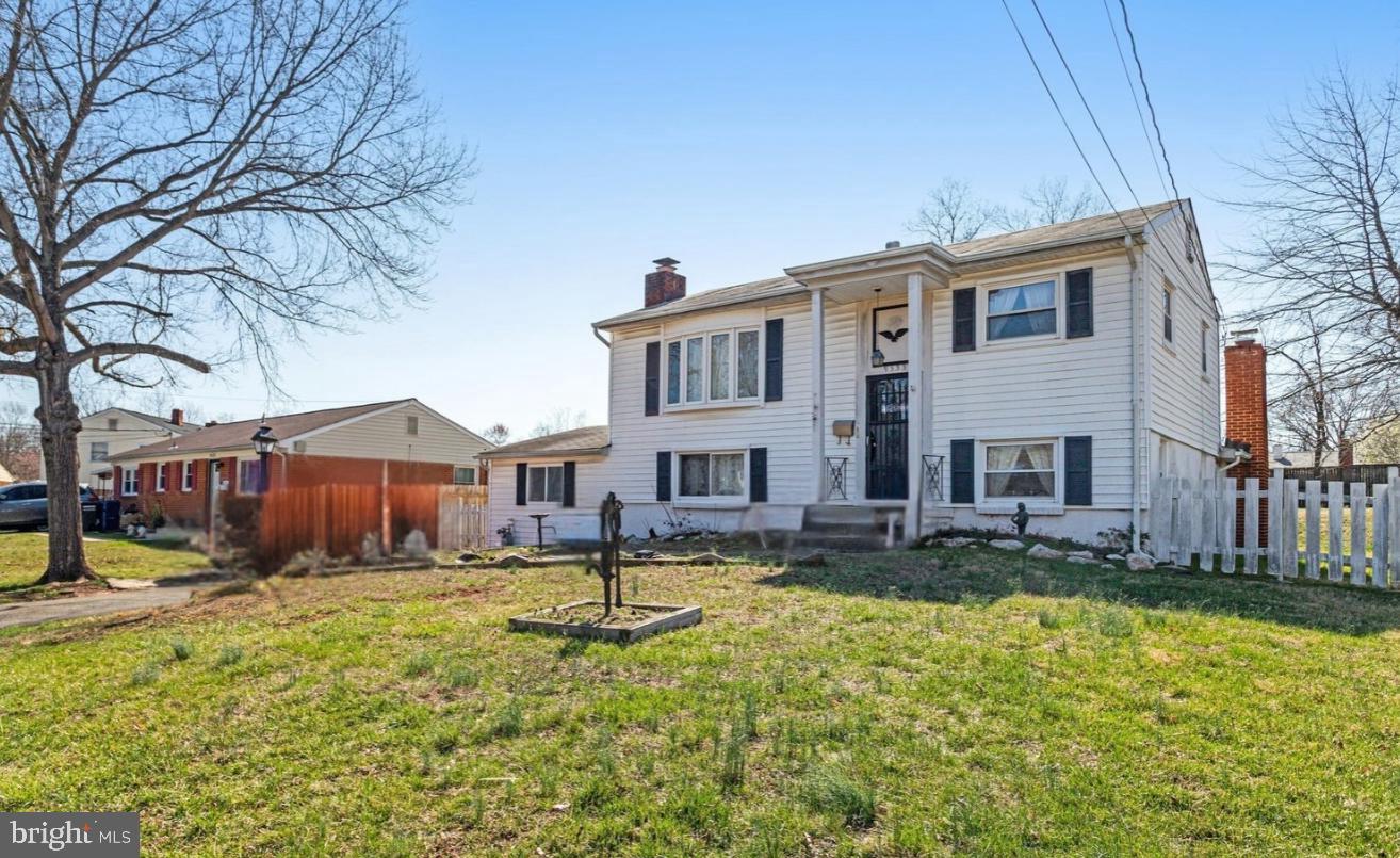 9535 Damascus Drive Manassas, VA 20109 - Photo 1 of 5 a front view of a house with a yard table and chairs
