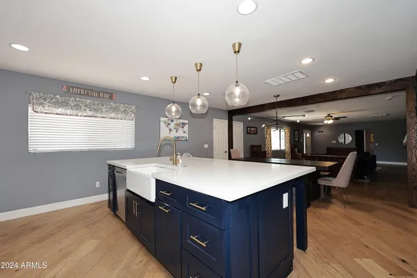 a kitchen with a dining table chairs sink and cabinets