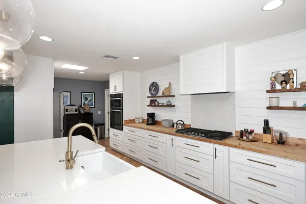 a kitchen with granite countertop a sink and cabinets
