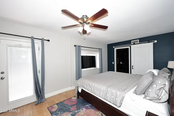 a bedroom with a bed and a ceiling fan