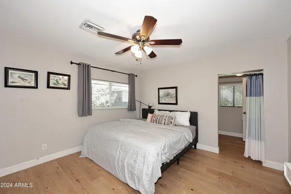 a view of a livingroom with a ceiling fan and wooden floor
