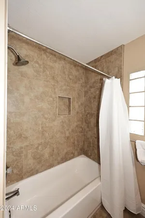 a bathroom with a granite countertop sink a toilet and bathtub