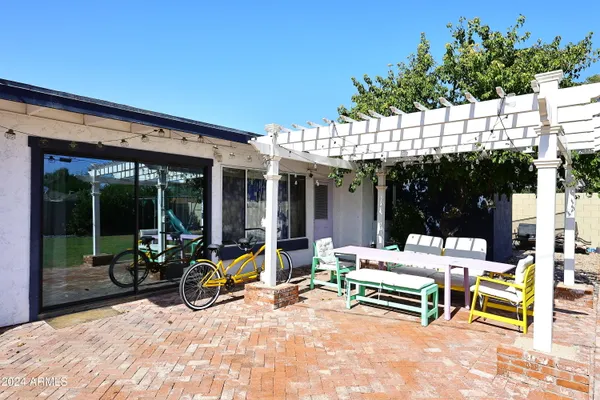 a building outdoor space with patio furniture and potted plants