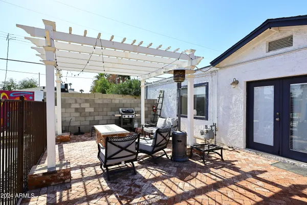 a view of a patio with table and chairs and potted plants