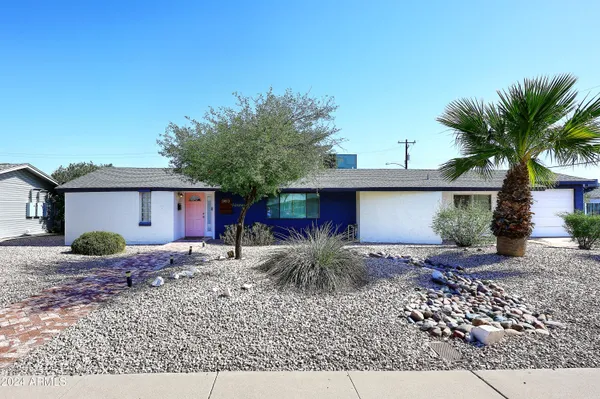 an aerial view of a house with a yard and a sitting area