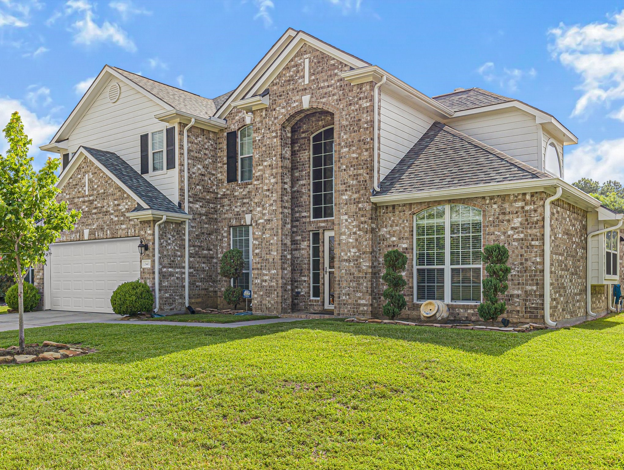 a front view of a house with a garden