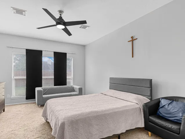 a bedroom with a bed and a couch